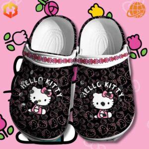 Black Hello Kitty Pattern Crocs Shoes on pink background with flower illustrations, showcasing ventilation holes and pink strap.