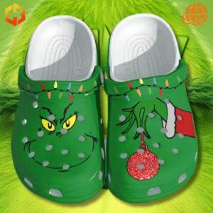 Christmas Light Grinch Crocs Shoes with green base, Grinch face on left, ornament on right, and colorful lights on both.