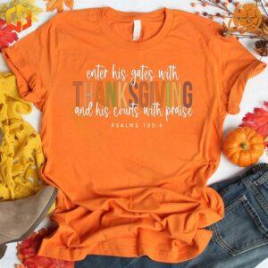 a 'Enter His Gates with Thanksgiving' t-shirt while holding a Bible