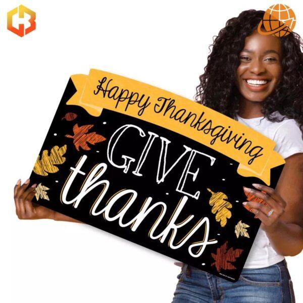 A festive yard sign that says 'Give Thanks Happy Thanksgiving