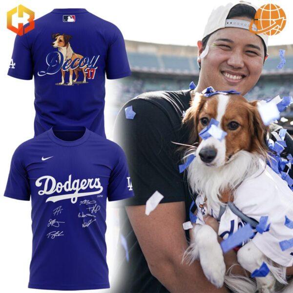 Front and back views of the Los Angeles Dodgers Decoy Dog Shirt in blue, featuring the Dodgers script logo and autographs on the front, with Decoy’s illustration and his name and number on the back.