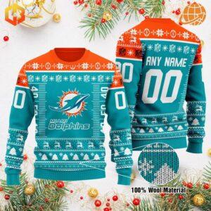 Miami Dolphins Xmas Sweater featuring team logo, customizable name and number, in team colors with holiday patterns, displayed with Christmas decorations.