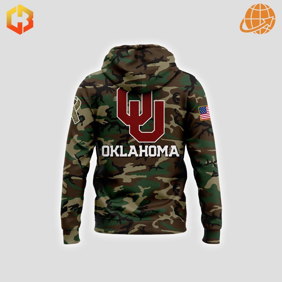 Back of Oklahoma Sooners Military Appreciation Hoodie displaying "OU" logo and "OKLAHOMA" text on camouflage pattern.