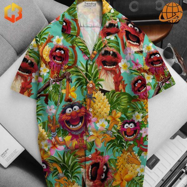 A whimsical Hawaiian shirt with Elmo and his Muppet pals enjoying a beach day.