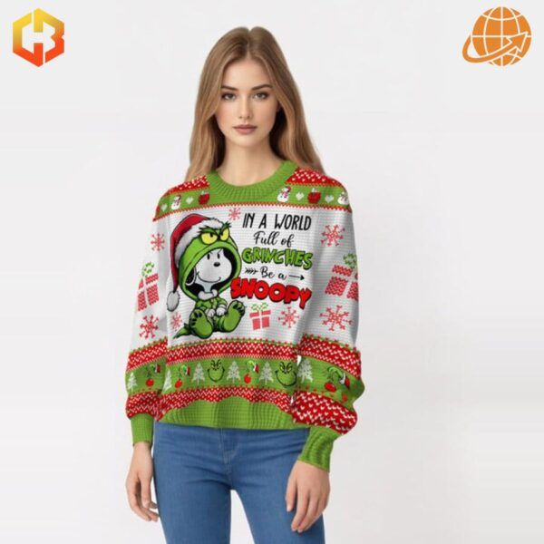 Person modeling the In A World Full Of Grinches Be A Snoopy Christmas Sweater.