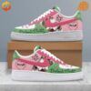 Pink, green, and white Nike Air Force 1 sneakers with Melanie Martinez-inspired artwork and text.