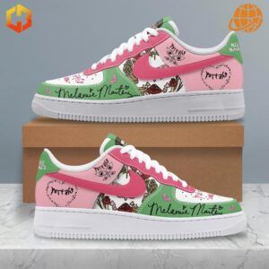 Pink, green, and white Nike Air Force 1 sneakers with Melanie Martinez-inspired artwork and text.