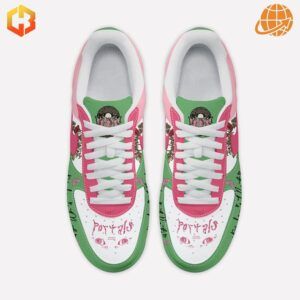 Overhead view of pink and green Nike Air Force 1 sneakers with Melanie Martinez-inspired designs.