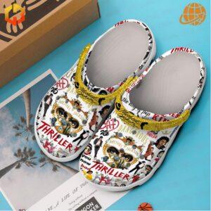 Michael Jackson Thriller Crocs Shoes on blue background with product box and promotional materials.