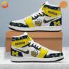 Michigan Wolverines Air Jordan 1 Shoes with bold yellow, white, and navy blue color scheme, featuring the team's logo and mascot embroidery.