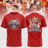 Front design of the NC State Wolfpack ACC Basketball Conference Tournament Champions Shirt with bold "Champions" text, ACC logo, trophy graphic, and celebratory rays on a red background.