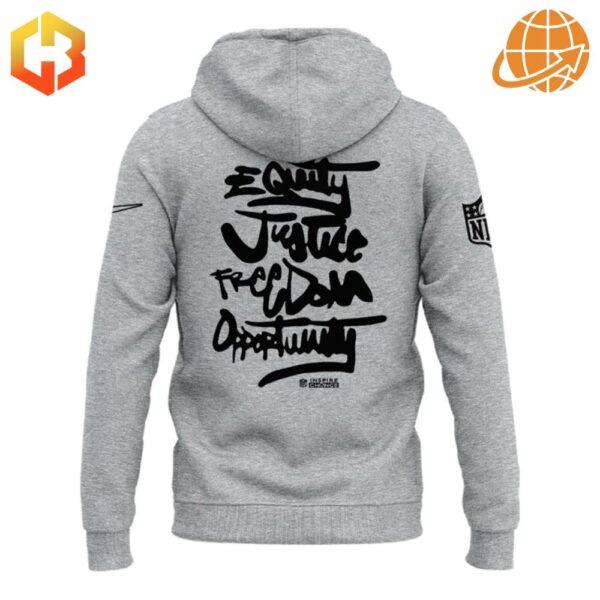 Back of grey hoodie with "Equity Justice Freedom Opportunity" handwritten text.