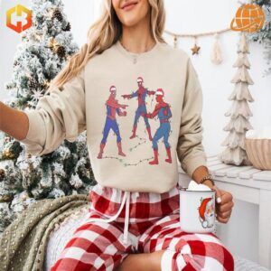 Cream-colored Spider-Man Pointing Meme Sweatshirt displayed in festive holiday scene.