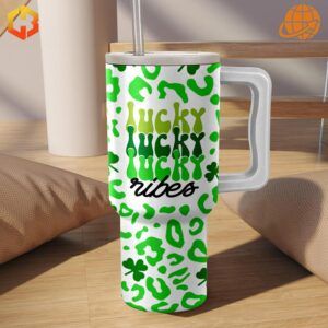 Starbucks Irish Coffee Lucky Stanley Tumbler with green design and “Lucky Lucky Vibes” slogan, placed in a warm, cozy setting.