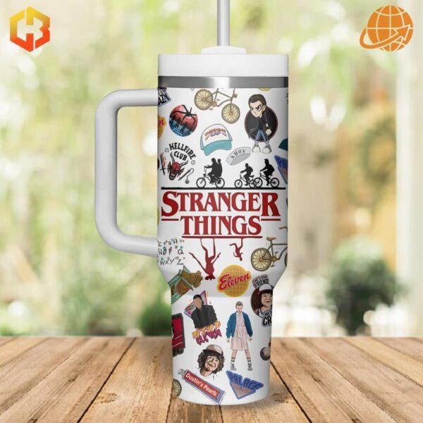 Eleven, Mike, Dustin, and Lucas, in cartoon style, adorn this stainless steel tumbler.