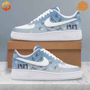 Side view of Taylor Swift 1989 Nike Air Force Shoes with light blue gradient, white snowflakes, bird silhouettes, and white Nike Swoosh.