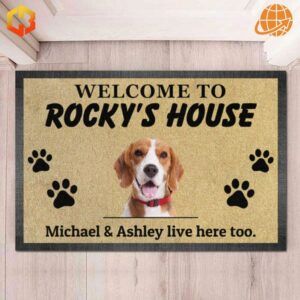 A personalized doormat with the text "Welcome to Rocky's House" featuring a Beagle's image, paw print designs, and the additional note, "Michael & Ashley live here too."