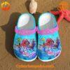 Ariel Disney Custom Crocs on beach with sea-themed accessories.