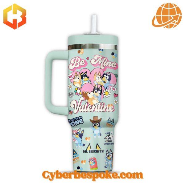 he 40oz tumbler features a mint green exterior adorned with vibrant Bluey character illustrations.