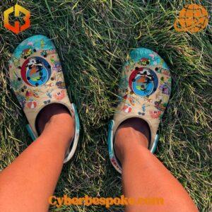 Person wearing Grateful Dead Summer Crocs Shoes on green grass, showing comfort and style.