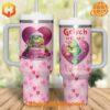 Two Grinch-themed Valentine's Day tumblers with heart designs