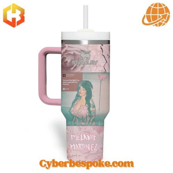 Side view of the Melanie Martinez Light Shower Stanley Tumbler Cup highlighting the pastel pink handle and built-in straw.