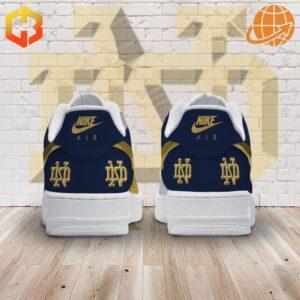 Rear view of Notre Dame navy and gold Nike Air Force shoes with logo on tongue