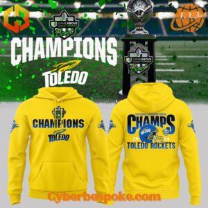 Yellow Toledo Rockets Football 2024 GameAbove Sports Bowl Champions Hoodie with "CHAMPIONS" text on the front and "CHAMPS 2024" graphic on the back.