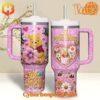 Pink Winnie the Pooh Valentine tumbler with floral, heart, and glitter designs, featuring a secure handle and straw lid.