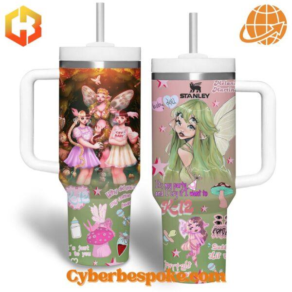 Two 40oz tumblers with handles displaying colorful Melanie Martinez-inspired artwork, including fairy characters and whimsical symbols.