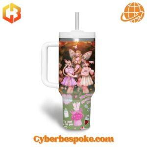 Two 40oz tumblers with handles displaying colorful Melanie Martinez-inspired artwork, including fairy characters and whimsical symbols.