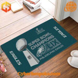 Philadelphia Eagles Super Bowl LIX Champions Doormat placed at home entrance with books and slippers nearby.